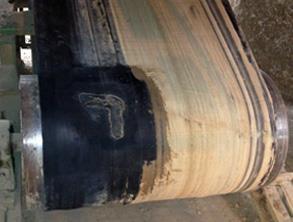 Torn conveyor belt prior to repair Torn conveyor belt prior to repair
