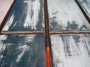 Corroded steel frame and degraded rubber seal on skylights