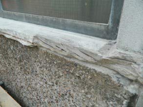 Spalled concrete window sill